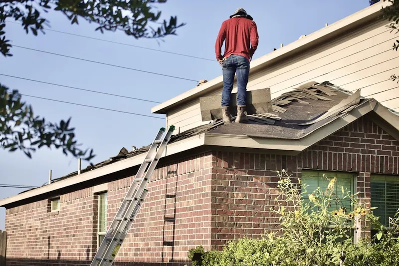 Professional roofer working on a residential roof in Deerbrook